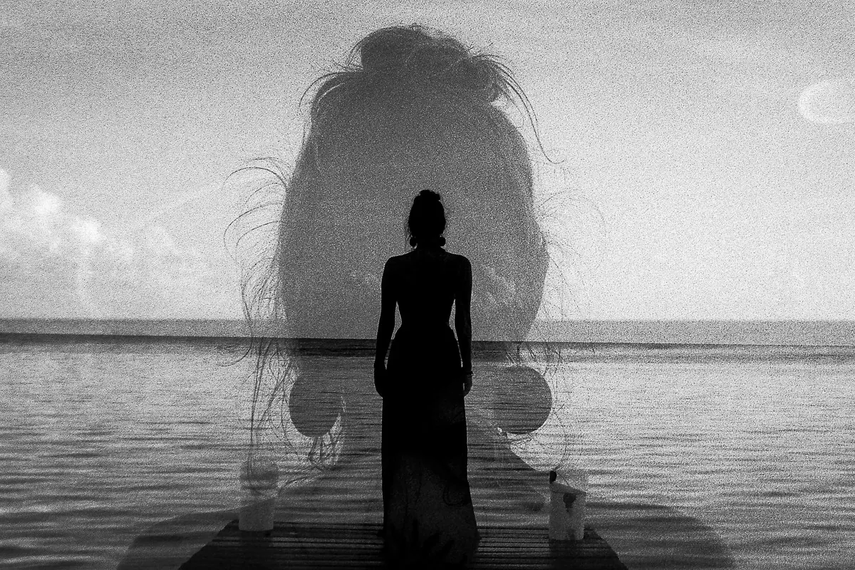 Dupla exposição: silhueta de mulher de costas diante do mar, sobreposta a um retrato de perfil